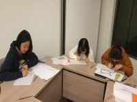 Ms TAN Brenda Hui Shan (left) at the English Calligraphy Workshop by the College in Term 2, 2018–19